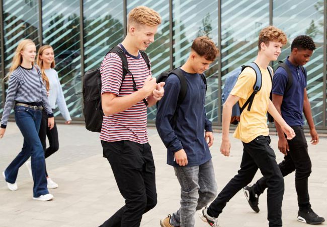 A two pairs of young people walking home